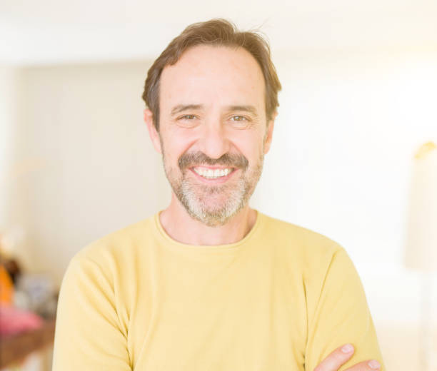 istock Handsome middle age man smiling looking at the camera at home 1124669191