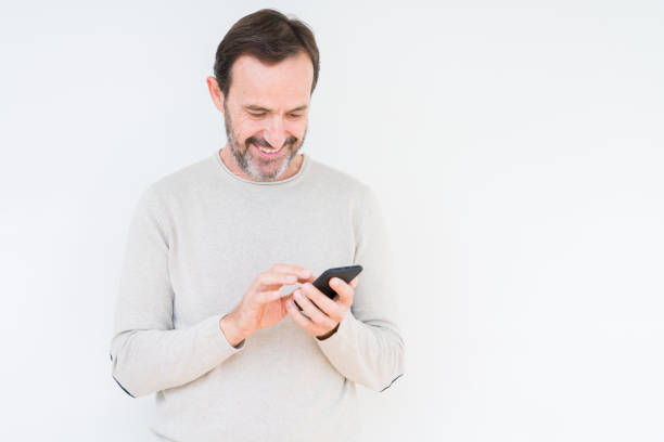 istock Senior man using smartphone over isolated background with a happy face standing and smiling with a confident smile showing teeth 1124670671