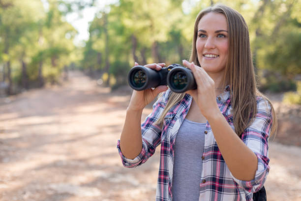 istock Young female traveler looking with binoculars 1124671459