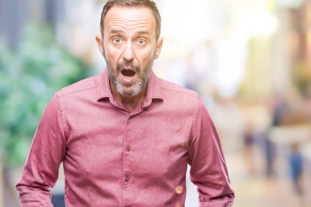 istock Middle age hoary senior man over isolated background afraid and shocked with surprise expression, fear and excited face. 1124671697