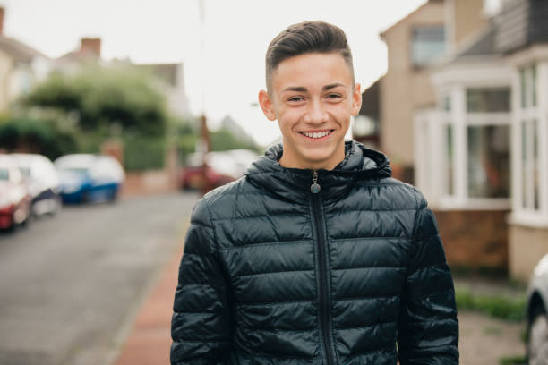 Portrait of a Smiling Teenage Boy Portrait of a teenage boy smiling towards the camera one teenage boy only stock pictures, royalty-free photos & images