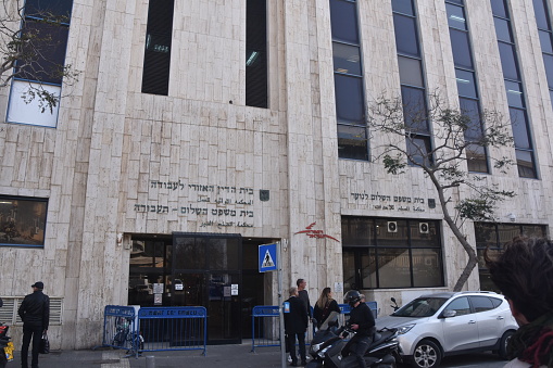 Tel Aviv, Israel :January 22, 2019: Entrance building to Court for Peace and Labor in Tel Aviv, Israel, In the picture you can see the main entrance, the building and the entrance sign.\nLocation: Schocken 25, Tel Aviv -Yafo, Israel .\nThe Regional Labor Court in Tel Aviv handles various aspects of the Labor and Social Security Law, including claims and appeals with the National Insurance Institute