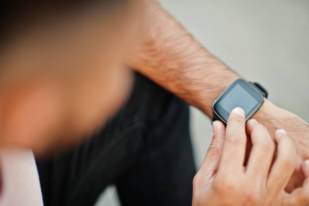 istock Smart black watch on the boy's hand from above. 1124684150