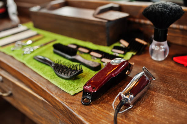 istock Barber tools on wooden background table with electric machines. 1124684425