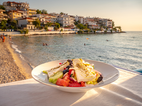 Traditional Greek Salad on a table near the beach in a traditional Greek Tavern in Skala Marion, Thasos, Greece
