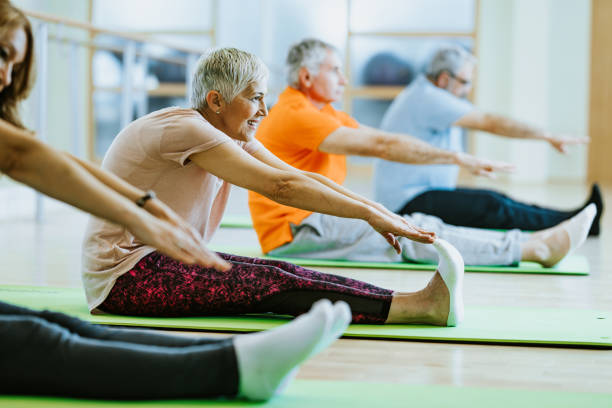 istock Senior people stretching during exercise class in health club. 1124688251