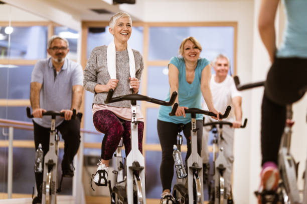 istock Happy mature people on exercising bikes during exercising class in a gym. 1124688961