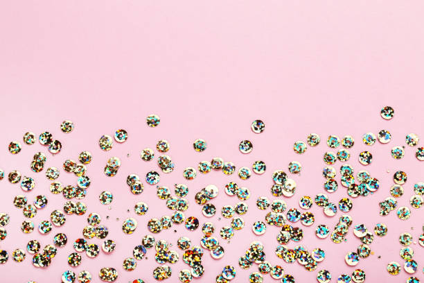istock Round colorful sequins on pink background 1124690112