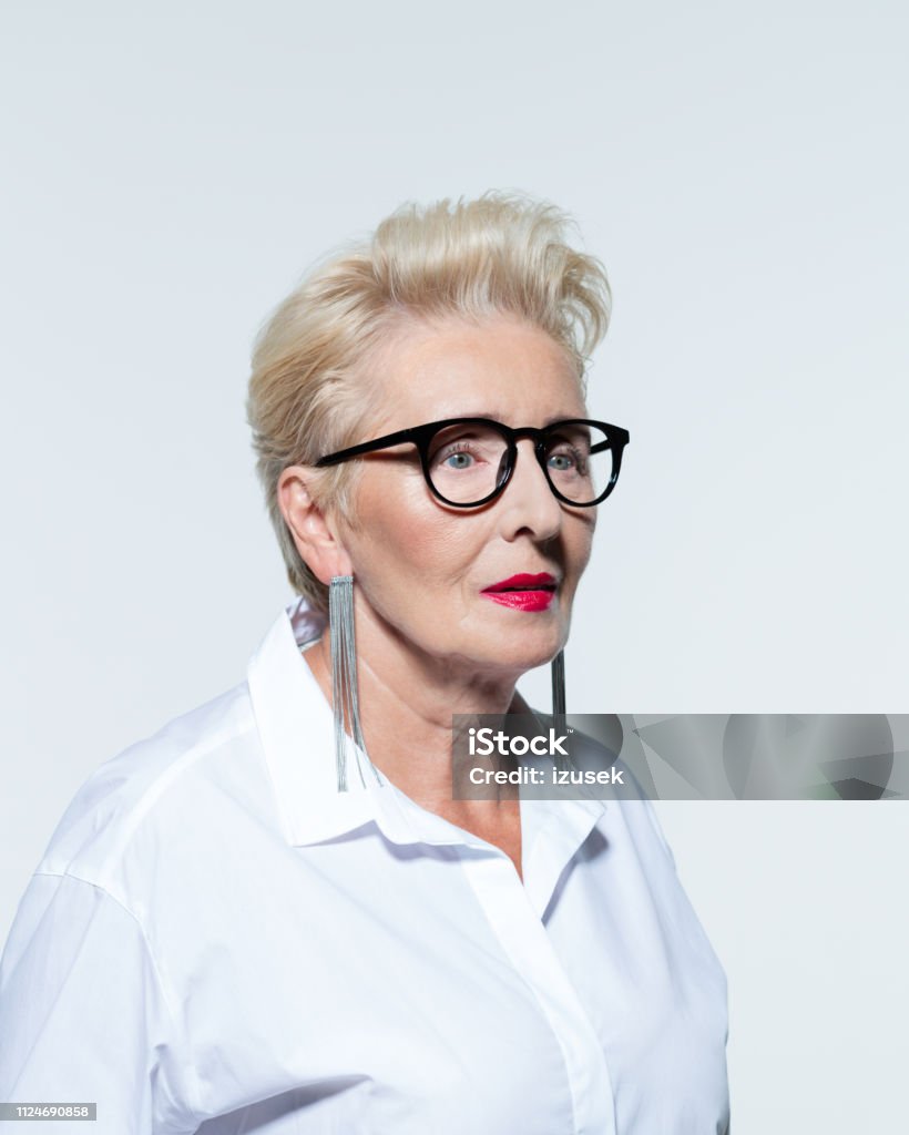 Portrait of elegant senior woman Glamour portrait of beautiful elegant senior woman, wearing white shirt and glasses. Anxiety Stock Photo