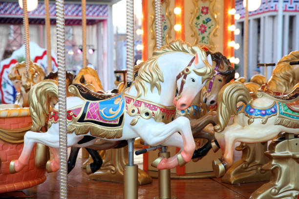 Children's carousel with horses at the festival Children's carousel with horses at the festival carousel photos stock pictures, royalty-free photos & images