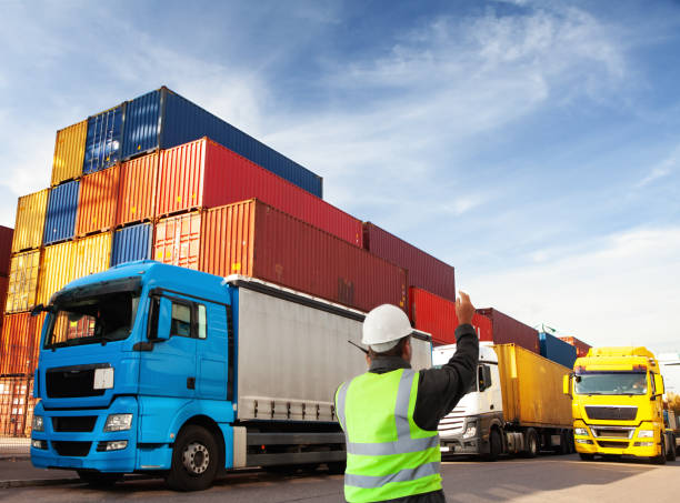 container terminal with trucks  with freight forwarding manager,worker cu of person working, low angle, cargo container shipping harbor trading stock pictures, royalty-free photos & images