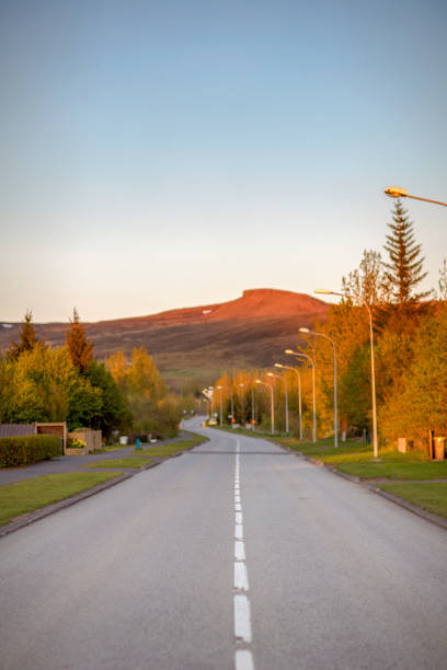 istock Empty road leading towards mountain against sky 1124697433