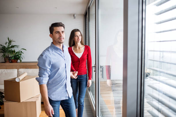 istock Young couple with cardboard boxes moving in a new home. 1124697764