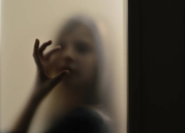 istock Girl behind frosted glass 1124699514