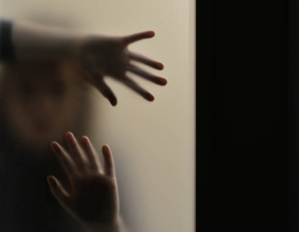istock Girl behind frosted glass 1124699522