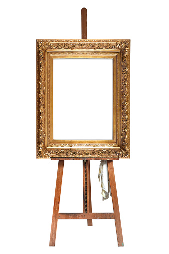 Painter's easel and empty antique golden frame isolated with clipping path