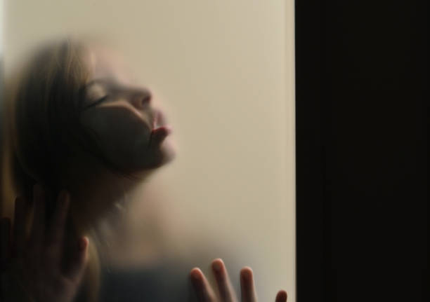 Girl with face pressed on frosted glass