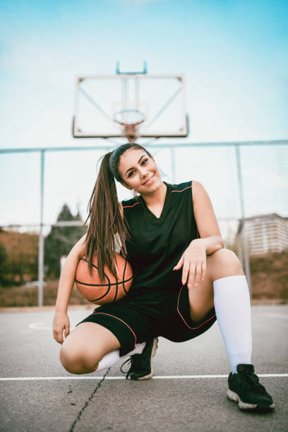 istock Cute Female Basketball Player Posing In Kneeling Position 1124700090