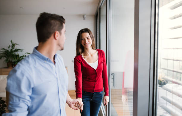 istock Young couple with cardboard boxes moving in a new home. 1124700408