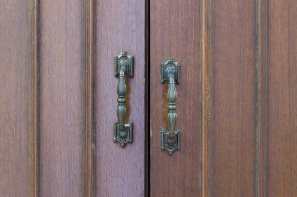 istock Wooden old grey wardrobe with  two metal handles as background 1124703859