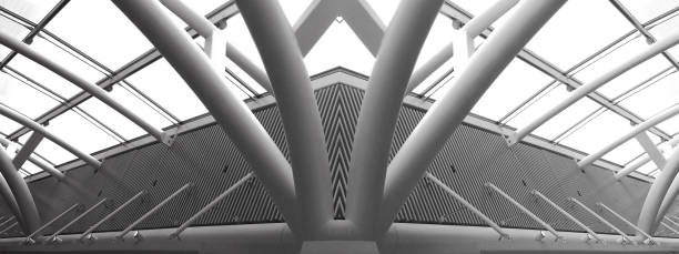 istock Computer graphic image of glass and metal structures resembling futuristic building. Abstract black and white modern architecture or construction industry image with multiple steel pillars / girders. 1124704822
