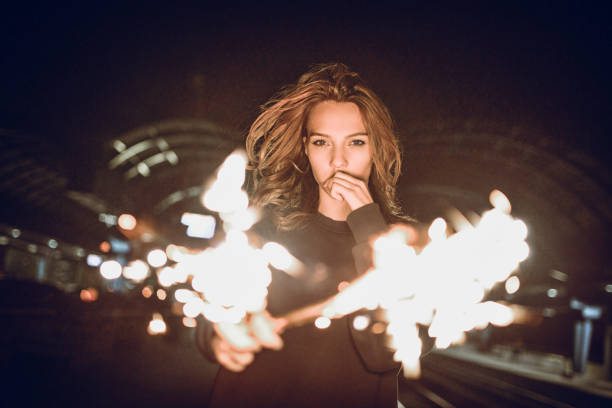 istock Adorable Female Playing With Firework At The Dark 1124704901