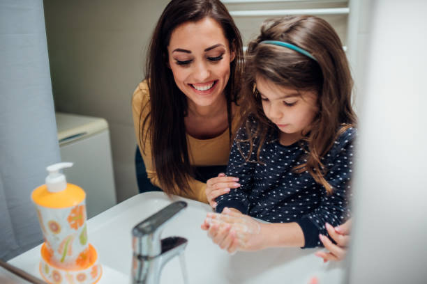 istock Family washing hands together 1124705084