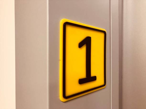 istock Number one in black color on yellow background 1124705182