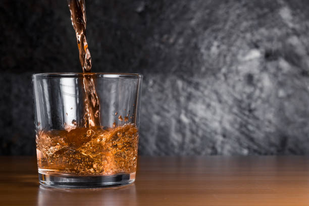 Alcohol poured into a glass stock photo