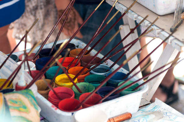 istock brushes are in cans of colored paint 1124707101