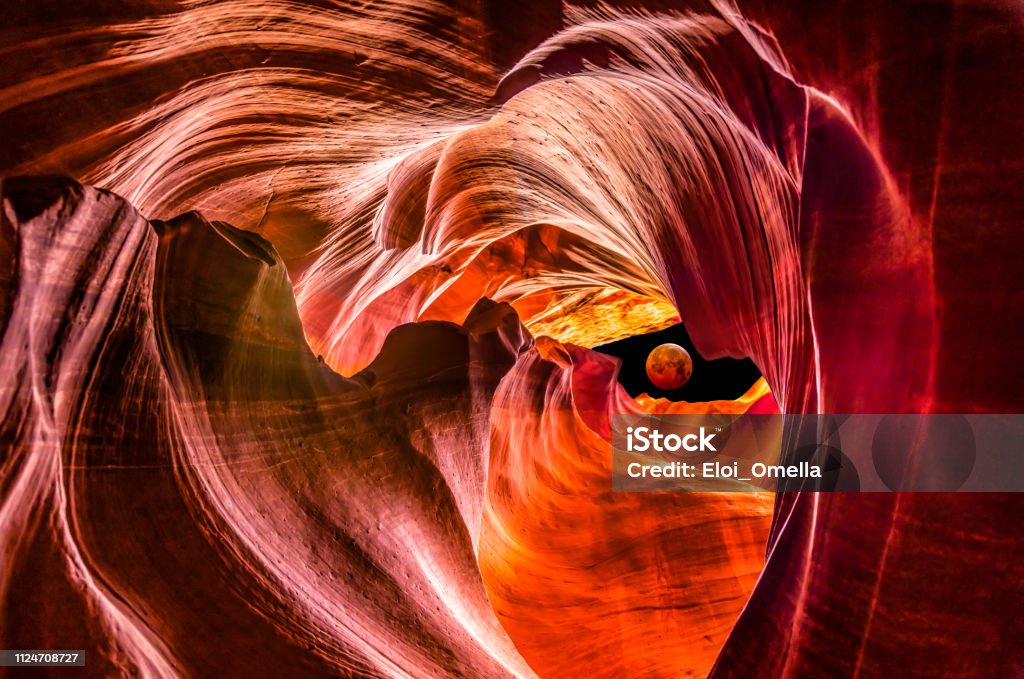 red supermoon eclipse in Upper Antelope Canyon Composite with Red full moon eclipse outside Upper Antelope Canyon Antelope Canyon Stock Photo