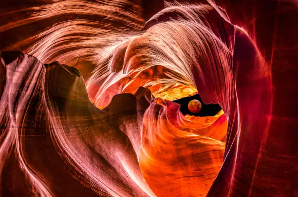 Composite with Red full moon eclipse outside Upper Antelope Canyon