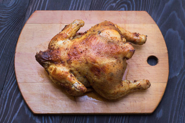 istock whole fried chicken in spices on a wooden tray 1124711519