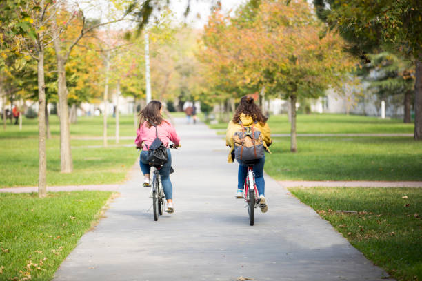 istock University students riding bikes outdoors 1124712597