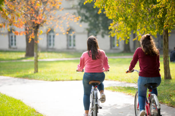 istock University students riding bikes outdoors 1124712598