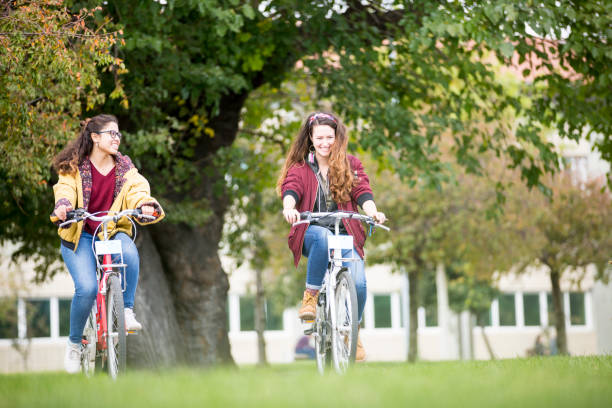 istock University students riding bikes outdoors 1124712600