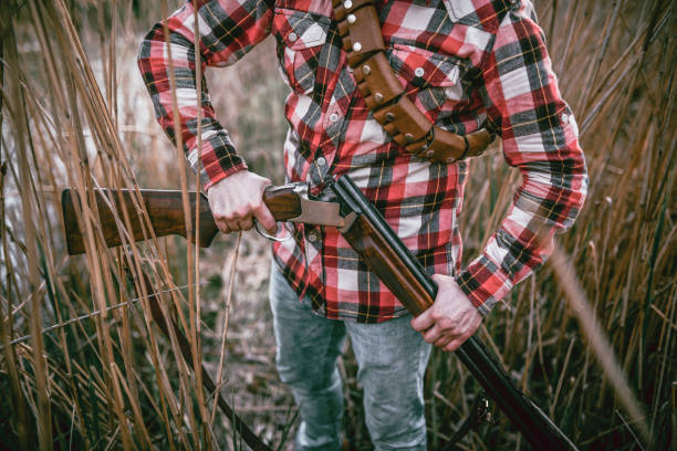 istock Hunter Putting Bullets in his Gun and Preparing for Hunting 1124713906