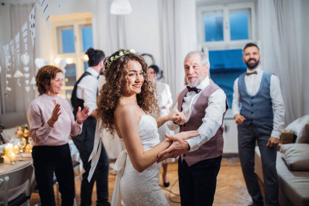 istock A young bride dancing with grandfather and other guests on a wedding reception. 1124714358