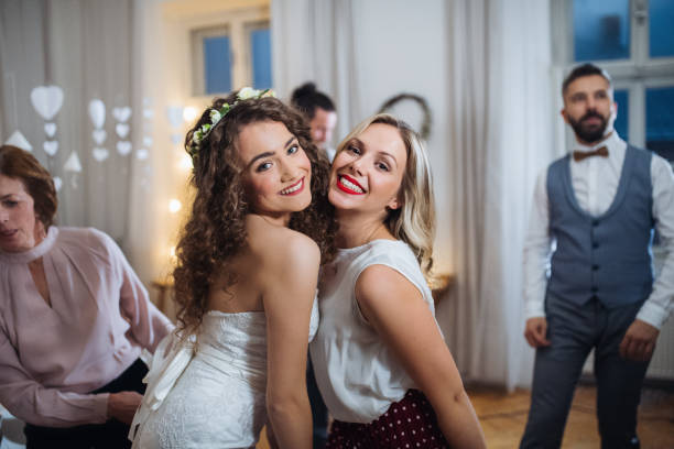 istock A young bride and her female friend posing on a wedding reception, dancing. 1124714882