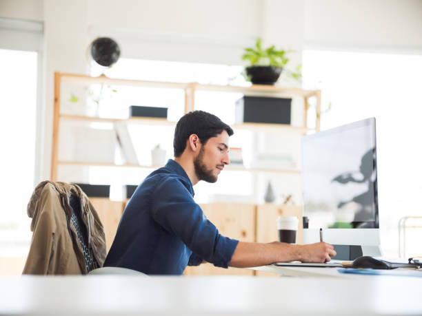 istock Latin young male working on his drawing tablet 1124714950