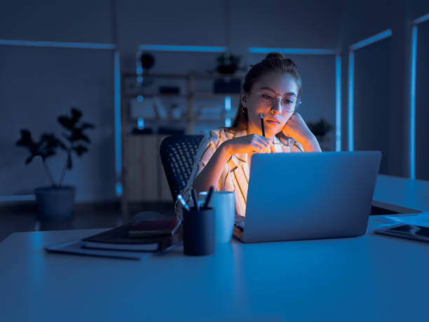 istock Millennial woman working late in the office 1124715056