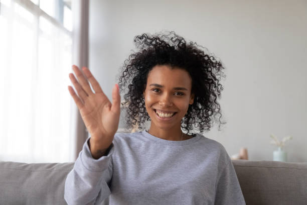 istock Smiling black young female waving having video call 1124715279