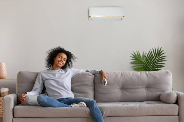 istock Calm black female relax on couch under air conditioner 1124715341