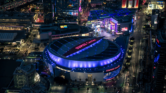 Los Angeles, California, USA - August 10, 2017: Aerial view of the Staples Center Arena at night. Staple Center is a multipurpose arena used for the basketball Los Angeles Lakers and Los Angeles Clippers basketball team.