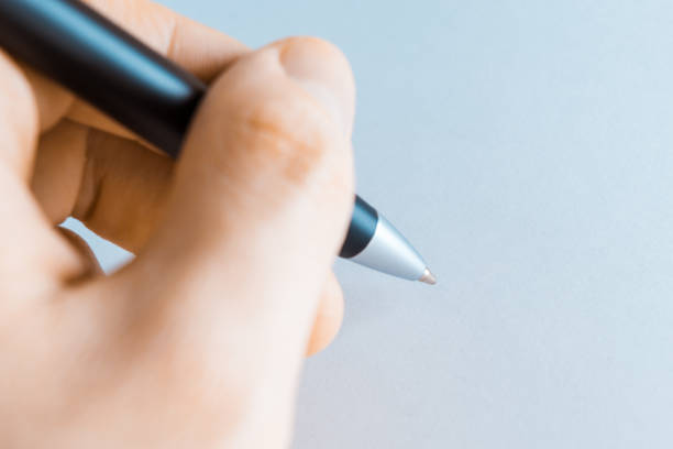 istock Left hand writing on white sheet holding a black pen 1124715714