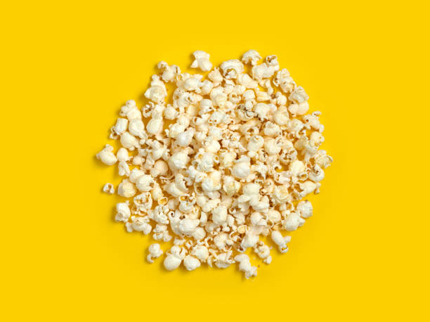 istock Closeup of popcorn against yellow background 1124717157
