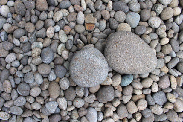 istock Big stones among smaller pebbles, in the garden. 1124717700