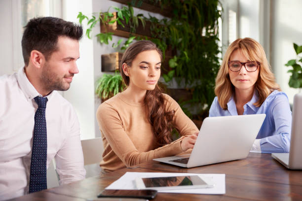 istock Group of business people using laptop while working in the office 1124718093