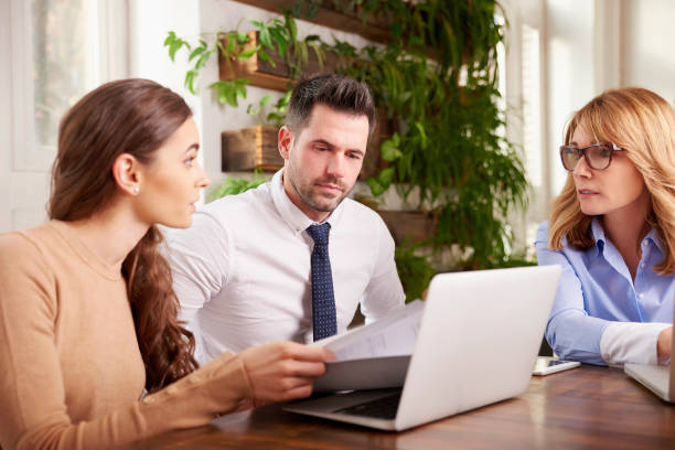 istock Group of business people using laptop while working in the office 1124718096