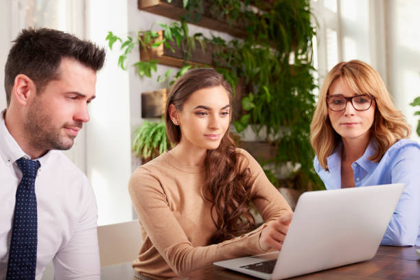 istock Group of business people using laptop while working in the office 1124718164